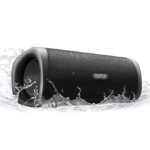 A black EarFun UBOOM L portable Bluetooth speaker splashing in water, highlighting its waterproof IP67 design and rugged build.
