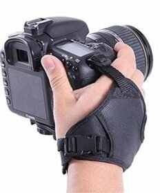 HIFFIN black PU leather camera hand grip wrist strap attached to a DSLR camera, providing secure and comfortable one-hand support